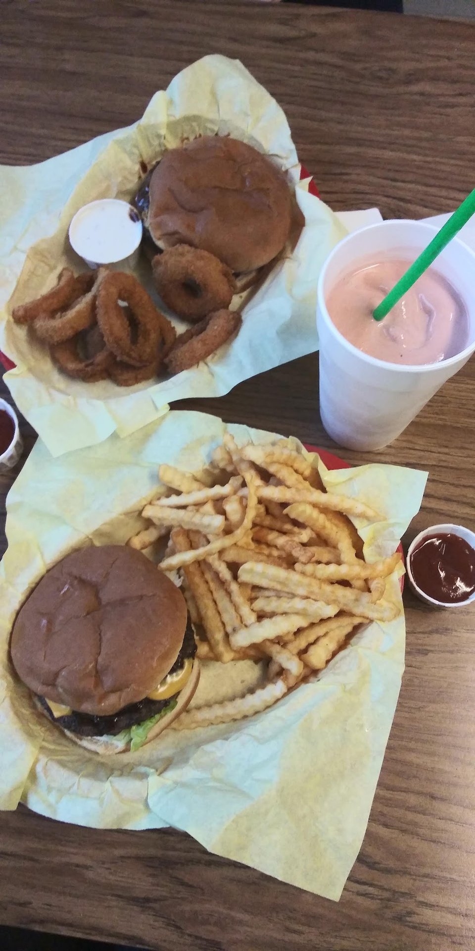 Menu board with burgers, salads, and shakes.